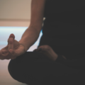 Person sitting and meditating using breath-work to regulate their nervous system
