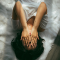 woman lying in bed in pain due to her vulvodyina.